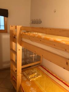 a wooden bunk bed in a room with at appartement in de Haute Savoie (Saint Jean de Sixt) in Saint-Jean-de-Sixt