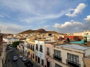 a view of a city with buildings and a mountain at Hotel Villarreal in Zacatecas