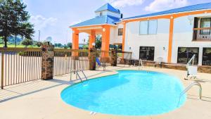a swimming pool in front of a house at Days Inn by Wyndham Decatur Priceville I-65 Exit 334 in Decatur