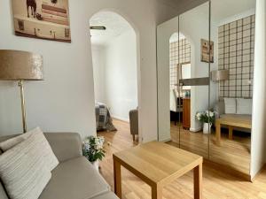a living room with a couch and a table at Little Connaught House in Portsmouth