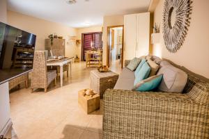 a living room with a couch and a table at casamarena in Costa Calma