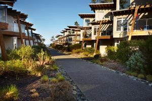 a walkway in front of a row of apartment buildings at Cox Bay Beach Resort in Tofino