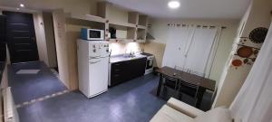 Il comprend une petite cuisine équipée d'un réfrigérateur blanc et d'un four micro-ondes. dans l'établissement MViejo, à Puerto Madryn