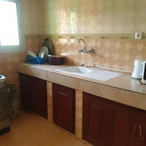 a kitchen with a sink and a counter top at Résidence La ROSÉE in Yaoundé +48 photos