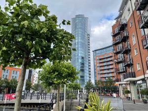 a tall glass building in the middle of a city at Somers House - pet friendly & parking in Portsmouth