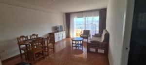a living room with a kitchen and a table and chairs at Apartamentos Florazar II in Cullera