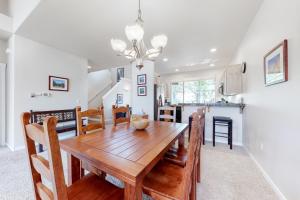 a dining room and kitchen with a wooden table and chairs at Pines and Blue Skies in Redmond
