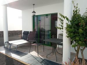 a patio with a table and chairs on it at Apartamento Maresia in Puerto del Carmen