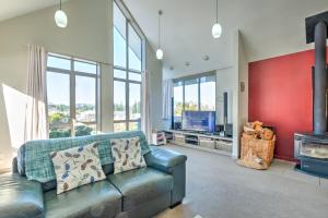 a living room with a couch and a fireplace at 55 St James Avenue in Hanmer Springs