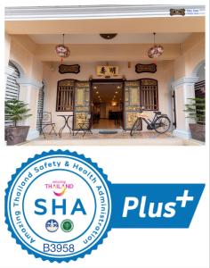 a building with a sha plus sign in front of it at Ming Shou Boutique House in Phuket