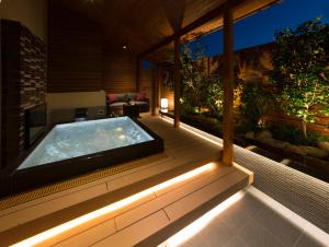 a hot tub on the deck of a house at HOTEL SWEET SEASON-L in Ginan