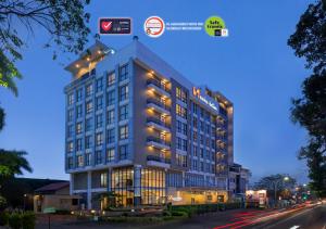 a rendering of a building on a city street at Swiss-Belinn Gajah Mada Medan in Medan