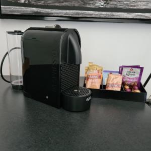 a microwave sitting on top of a counter with snacks at Quays Hotel in Batemans Bay