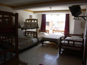 a room with two bunk beds and a window at La Cabaña in Huaraz +17 photos
