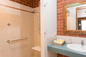 a bathroom with a sink and a shower with a mirror at Yackandandah Central in Yackandandah