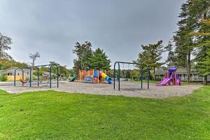a park with a playground with slides at Walk to Lake Tobyhanna Home with Hot Tub and Fire Pit in Tobyhanna