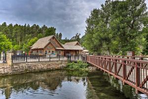 uma casa de madeira numa ponte sobre um rio em Central Creekfront Spearfish Apt by City Park em Spearfish