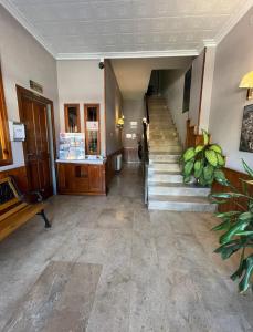 a lobby with a staircase and a stair case at HOTEL MORELL in El Morell