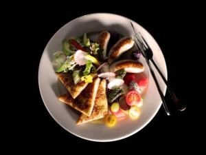 a white plate of food with a salad and toast at zmaxhotels 无锡新加坡工业园机场店 in Wuxi