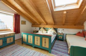 una camera con 2 letti e un soffitto in legno di Ferienwohnungen Penners a Aschau im Chiemgau