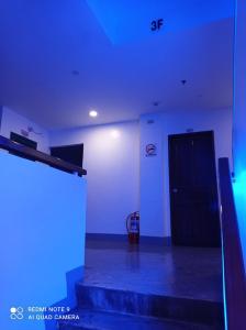 a room with blue lights and a black door at 8 Zhensen Inn in Bacoor +17 photos