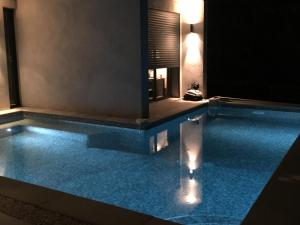 a swimming pool in a house with blue water at Villa 5* Nice St Pancrace in Nice +30 photos