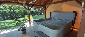 a hot tub in a room with a view of a garden at Diófa Vendégházak in Tiszafüred