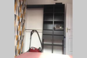 ein Zimmer mit Bücherregal neben einer Tür in der Unterkunft Appart Cosy Annœullin - Proche toutes commodités in Annoeullin
