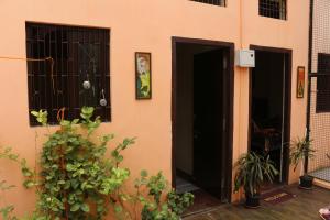 a house with a black door and some plants at Mother Hostel in Varanasi