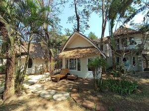 a house with a bench in front of it at Saffron On The Sea Resort in Ko Chang