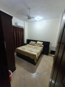 a bedroom with a bed with two pillows on it at Abeer Suites in Hurghada