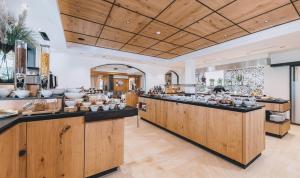 a kitchen with wooden cabinets and a counter top at Hotel Barbarahof Saalbach in Saalbach Hinterglemm