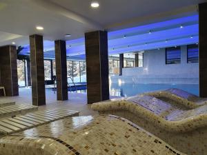 a bedroom with a bed and a swimming pool at Apartman Žuta dunja - Sunčani breg in Kopaonik