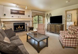 a living room with a couch and a fireplace at Townsend Place B-106 condo in Beaver Creek