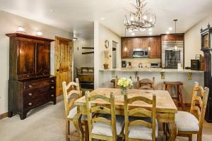a kitchen and dining room with a wooden table and chairs at Townsend Place B-106 condo in Beaver Creek