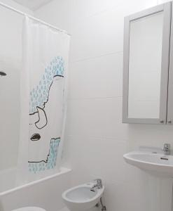a white bathroom with a sink and a shower curtain at A Mercé in A Pobra do Caramiñal +39 photos