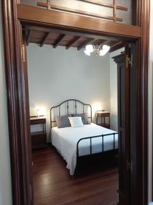 a bedroom with a bed and two night stands at A Mercé in Pobra do Caramiñal