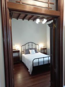a bedroom with a bed and two night stands at A Mercé in A Pobra do Caramiñal