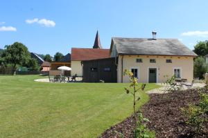 a house with a grassy yard in front of it at Jurahaus Pröll Ottmaring in Dietfurt