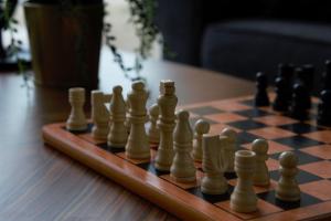 a chess board with chess pieces on a table at Apartamenti Vējdzirnavas in Ventspils