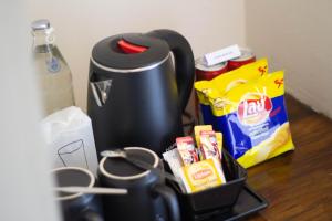 a coffee maker sitting on a table next to some food at Montree Phuket Hotel in Phuket Town