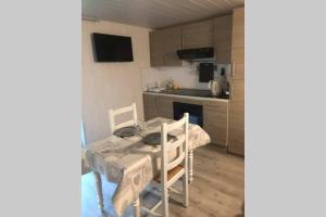 a kitchen with a table and chairs in a room at Appartement ST Roch in Salins-les-Bains