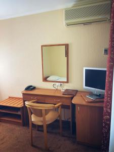 a room with a desk with a computer and a mirror at Park Hotel Fili in Moscow