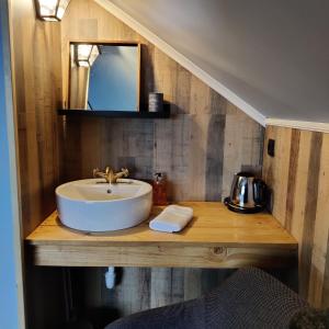 a bathroom with a sink on a wooden counter at Prestshús 2 Guesthouse in Vík