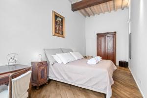 1 dormitorio con cama y escritorio de madera en Palazzo della Pilotta Roomy and Quiet Flat, en Parma