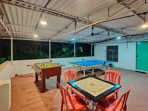 a room with two ping pong tables and chairs at Morocco Green Villa in Nagaon
