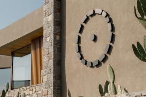 a building with a circular window on the side of it at Acro Suites - A Wellbeing Resort in Agia Pelagia