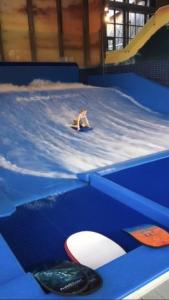 a person on a surfboard in an inflatable at In the middle of Trysil fjellet - Welcome Center - Apartment with 4 bedrooms and sauna - By bike arena and ski lift in Trysil