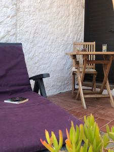 a bed and a table and a chair on a patio at Villa Troc Pinell in Banyuls-sur-Mer +40 photos