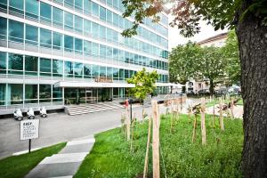 a building with a tree in front of it at Hotel Daniel Vienna - Smart Lifestyle Near City Centre in Vienna